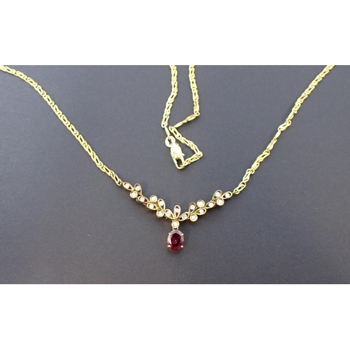 161 - A Ruby and Diamond Necklace the front claw-set oval-cut ruby suspended below leaf effect mount set b... 