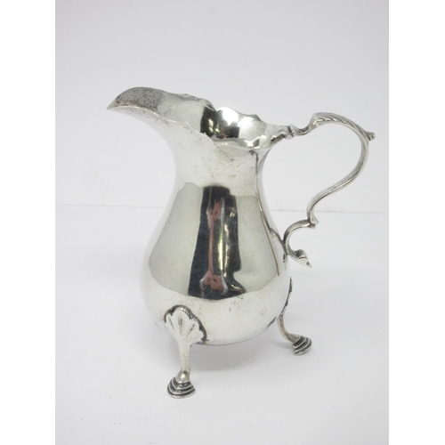 17 - A George V silver Cream Jug with shaped rim on hoof feet, Chester 1930