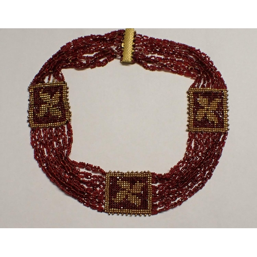 170 - A garnet coloured and gilt metal Bead Collarette on scale engraved gilt metal clasp