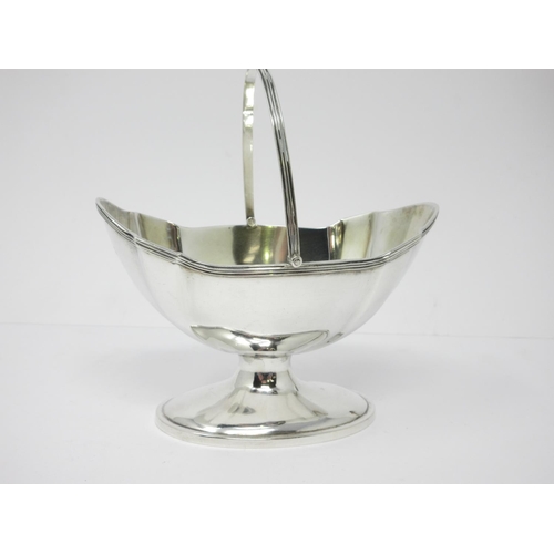 18 - A Victorian silver oval Sugar Basket with swing handle on pedestal base, London 1884