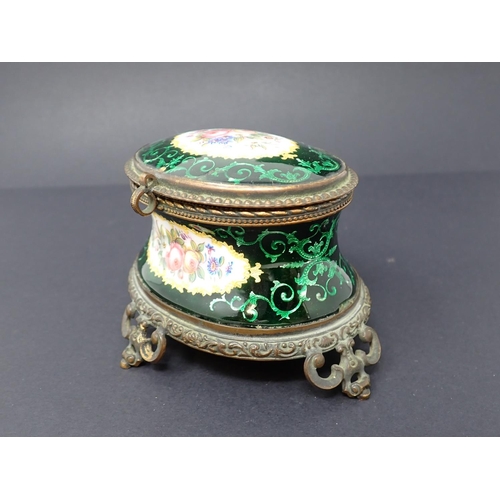 191 - A French enamel oval Casket with concave sides, hinged lid, decorated reserves of flowers with green... 