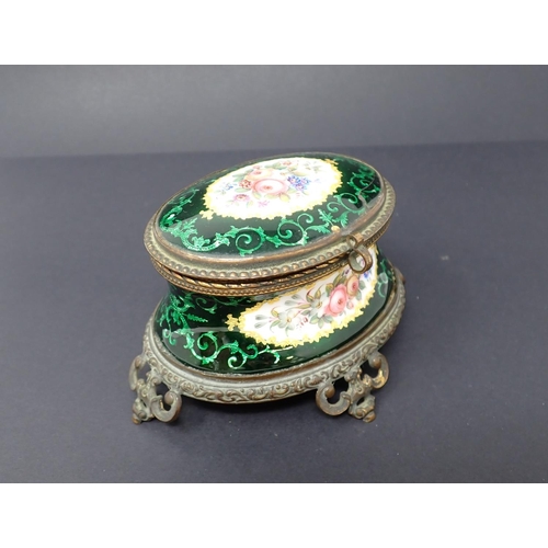 191 - A French enamel oval Casket with concave sides, hinged lid, decorated reserves of flowers with green... 