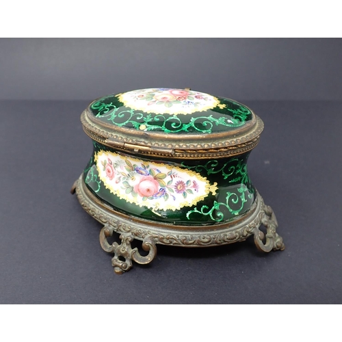 191 - A French enamel oval Casket with concave sides, hinged lid, decorated reserves of flowers with green... 