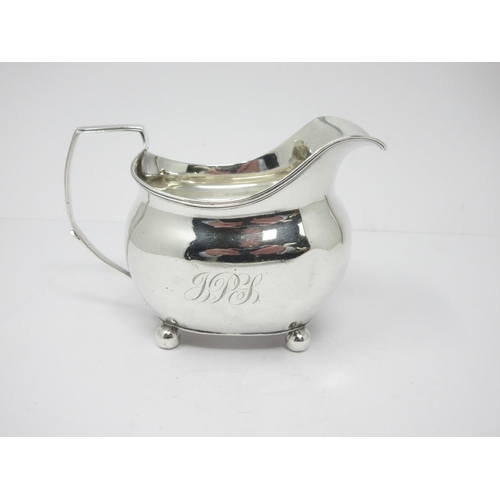 24 - A George III silver boat shape Milk Jug with reeded rim, engraved initials, on ball feet, London 180... 