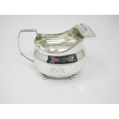 24 - A George III silver boat shape Milk Jug with reeded rim, engraved initials, on ball feet, London 180... 