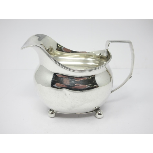 24 - A George III silver boat shape Milk Jug with reeded rim, engraved initials, on ball feet, London 180... 