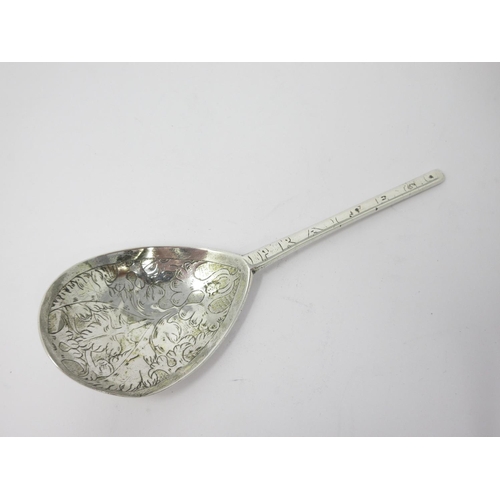 25 - A 17th Century silver Spoon with leafage engraved pear shape bowl, the reverse with initials and dat... 