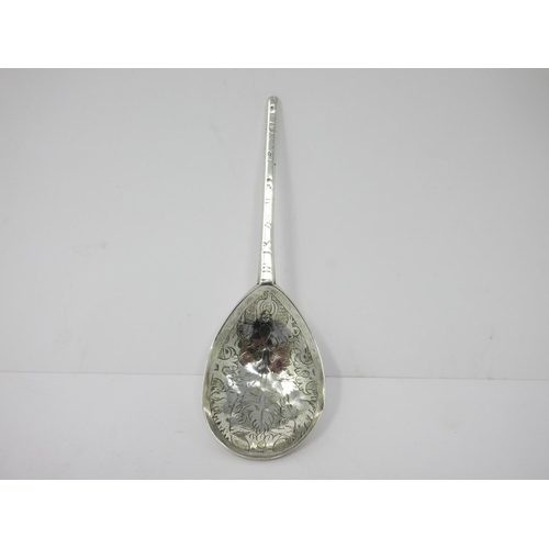 25 - A 17th Century silver Spoon with leafage engraved pear shape bowl, the reverse with initials and dat... 