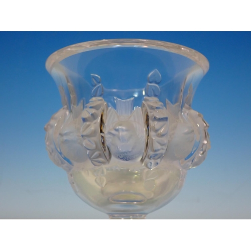 253 - A Lalique glass Vase with panels of young birds with moulded stylised seeds as divisions on circular... 