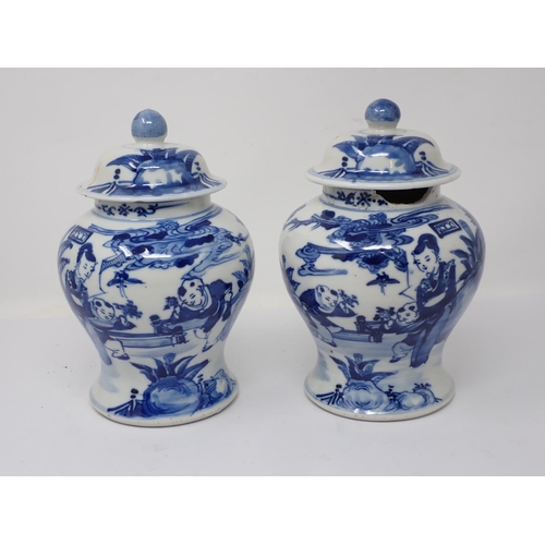 257 - A pair of 19th Century Chinese blue and white lidded Jars with figures within landscapes (one rim A/... 