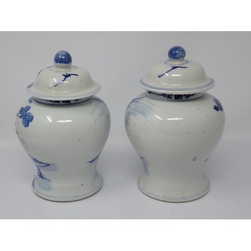 257 - A pair of 19th Century Chinese blue and white lidded Jars with figures within landscapes (one rim A/... 