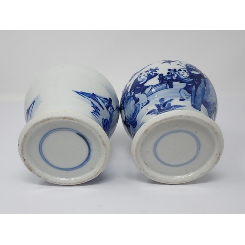 257 - A pair of 19th Century Chinese blue and white lidded Jars with figures within landscapes (one rim A/... 