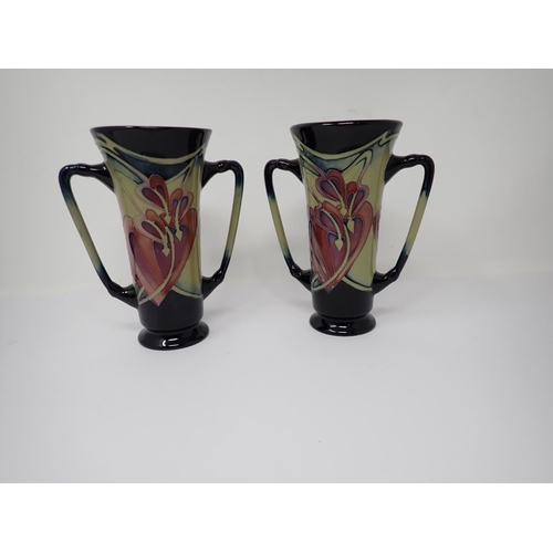 266 - A small pair of Moorcroft two handled Vases with hibiscus type floral design, dated 2008, 6in H