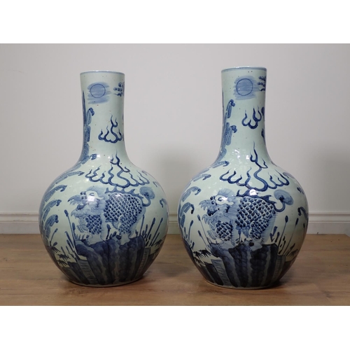 271 - A large pair of Chinese blue and white Vases, bottle shaped and decorated dragons amongst foliage in... 