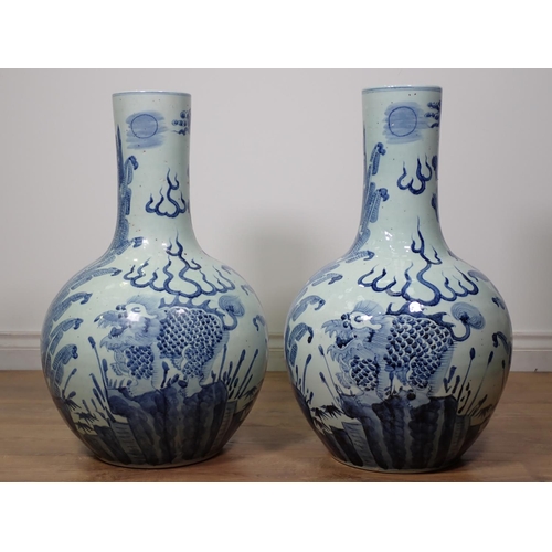 271 - A large pair of Chinese blue and white Vases, bottle shaped and decorated dragons amongst foliage in... 