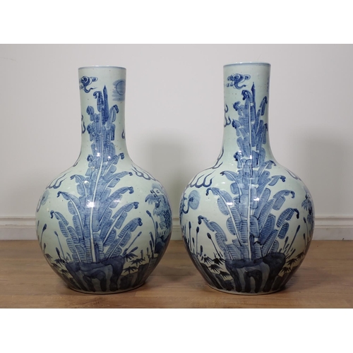 271 - A large pair of Chinese blue and white Vases, bottle shaped and decorated dragons amongst foliage in... 