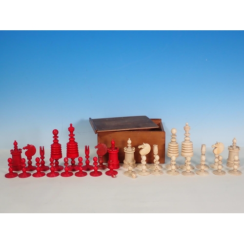 277 - A carved and turned bone Chess Set in red and natural, King 4 1/2in H, in box, one red knight replac... 