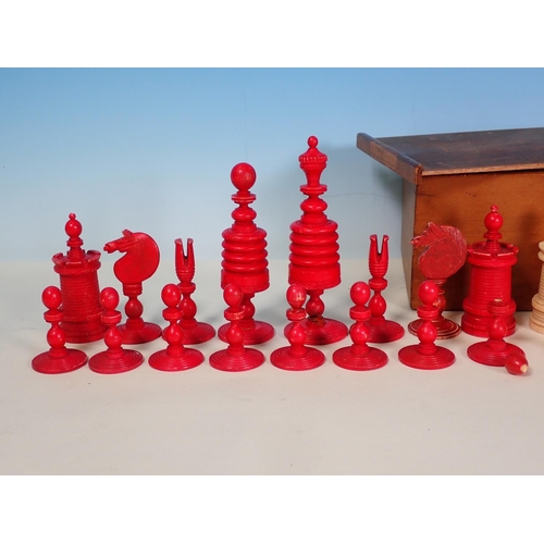 277 - A carved and turned bone Chess Set in red and natural, King 4 1/2in H, in box, one red knight replac... 