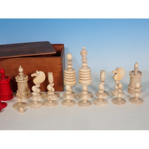 277 - A carved and turned bone Chess Set in red and natural, King 4 1/2in H, in box, one red knight replac... 