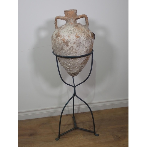 291 - A terracotta Roman Amphora Vase with marine encrustations, 22in high on metal stand