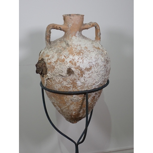 291 - A terracotta Roman Amphora Vase with marine encrustations, 22in high on metal stand