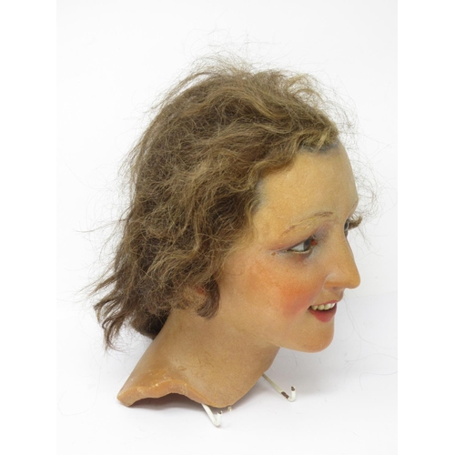 304 - An early 20th Century female wax mannequin Head with plaited brown hair and brown eyes