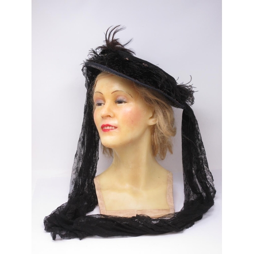 306 - An early 20th century wax mannequin Head with blonde hair and a 1920's style Hat