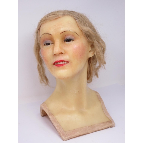 306 - An early 20th century wax mannequin Head with blonde hair and a 1920's style Hat