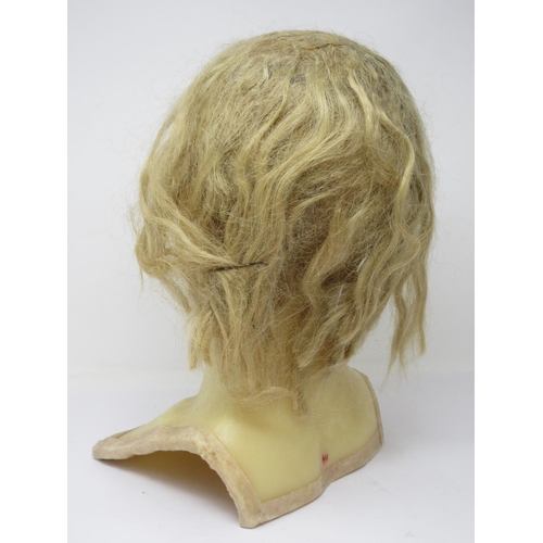 306 - An early 20th century wax mannequin Head with blonde hair and a 1920's style Hat