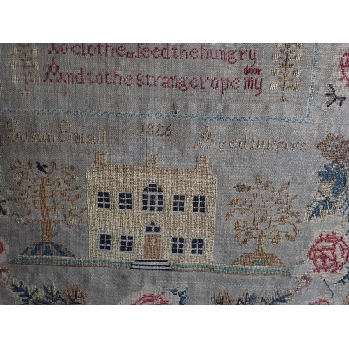 311 - A Georgian silk on tabby Sampler embroidered alphabet, birds, animals, verse and a house within flor... 