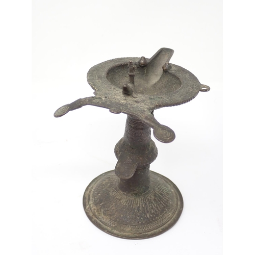 317 - An antique Indian bronze Orissa Oil Lamp with bird finial on circular base 6 1/4in H