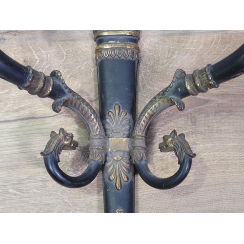 328 - A two branch Wall Light with flame finial, the scrolled arms with mythical head finials, 1ft 10in H