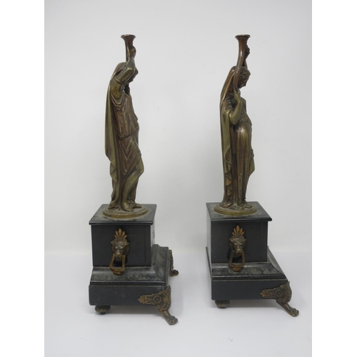 329 - A pair of bronze female Figures, holding torches on black slate bases with bronze paw supports, 1ft ... 