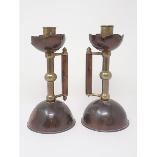 338 - A pair of Arts and Crafts brass and copper Candlesticks in the manner of Christopher Dresser with wo... 