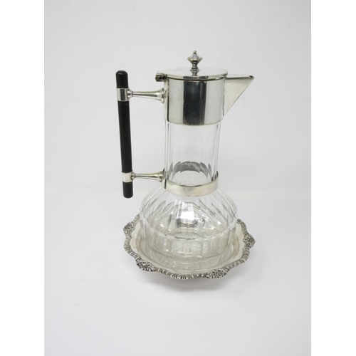 35 - A plated mounted cut glass Claret Jug in the manner of Christopher Dresser with ebonised handles, an... 