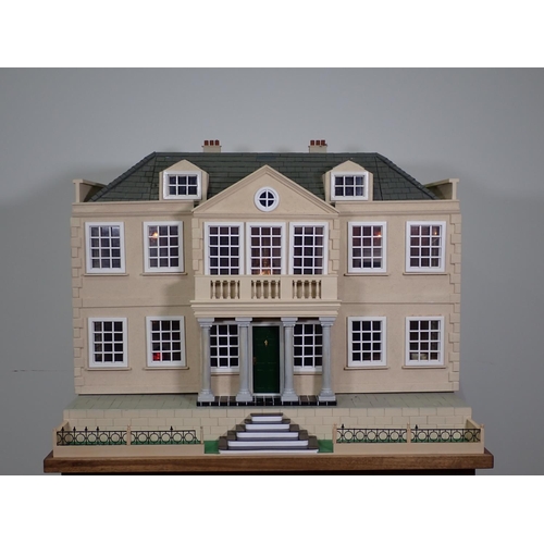 383 - A large Doll's House in the Georgian manner, with removable front panel revealing a lit fitted inter... 