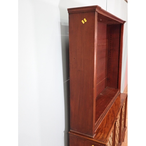 386 - A Regency mahogany open Bookcase with adjustable shelves upon base fitted three brass lattice and li... 