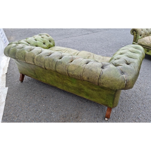 391 - A green leather button upholstered Chesterfield Settee on turned walnut front supports and casters, ... 