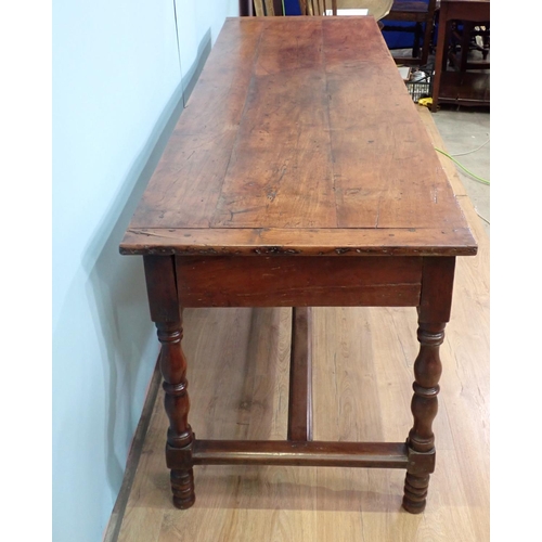 394 - An 18th Century French cherry Farmhouse Table with cleated three plank top mounted upon turned suppo... 