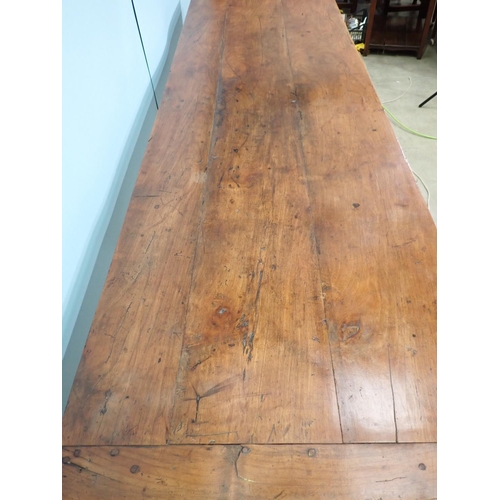 394 - An 18th Century French cherry Farmhouse Table with cleated three plank top mounted upon turned suppo... 