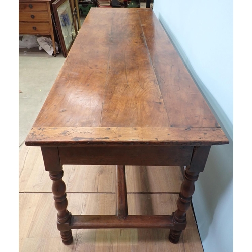 394 - An 18th Century French cherry Farmhouse Table with cleated three plank top mounted upon turned suppo... 