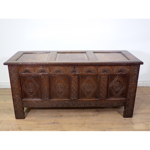 399 - A 17th Century oak four panel Coffer with lunette carved frieze and interlocking design on stile sup... 