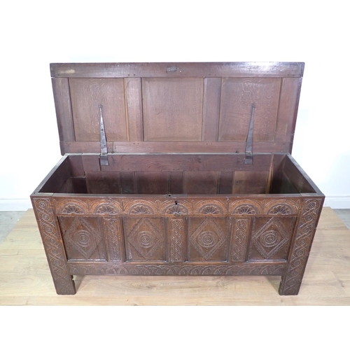 399 - A 17th Century oak four panel Coffer with lunette carved frieze and interlocking design on stile sup... 