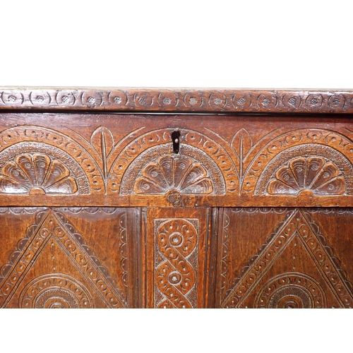 399 - A 17th Century oak four panel Coffer with lunette carved frieze and interlocking design on stile sup... 