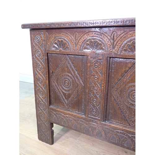 399 - A 17th Century oak four panel Coffer with lunette carved frieze and interlocking design on stile sup... 