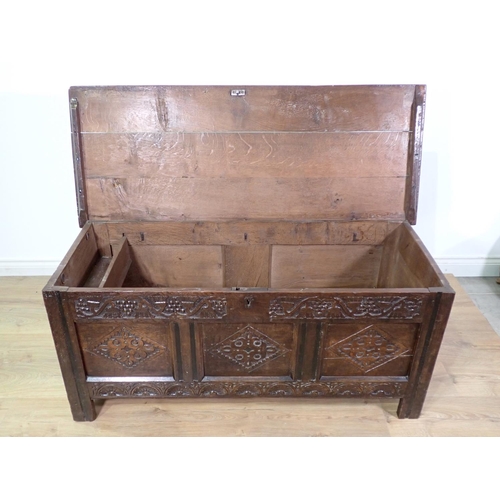 400 - A 17th Century oak three panel Coffer with moulded lid above grape and thistle frieze and diamond ca... 