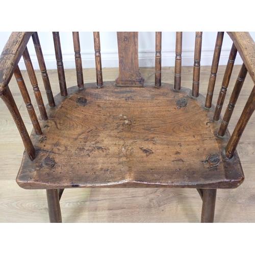 401 - A primitive Windsor Armchair in elm, oak etc with shaped solid splat and turned spindles, dished sea... 