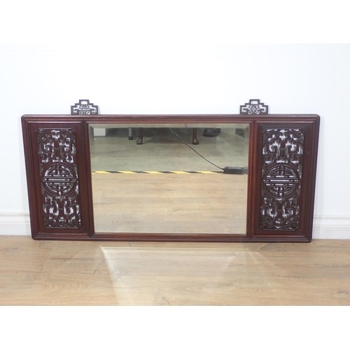 406 - A Chinese rosewood framed Mirror with pierced design incorporating bats to the corners flanking a be... 