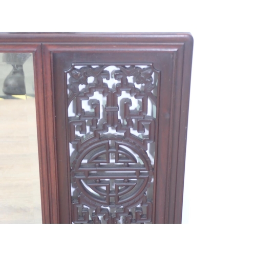 406 - A Chinese rosewood framed Mirror with pierced design incorporating bats to the corners flanking a be... 