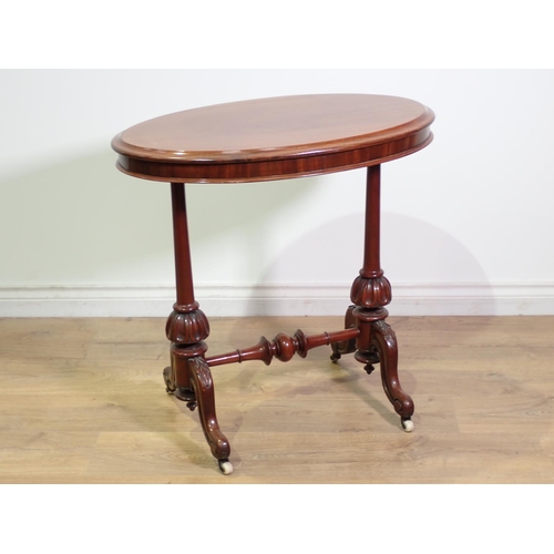 408 - A Victorian mahogany oval Occasional Table mounted upon turned cheval supports and leafage carved sc... 